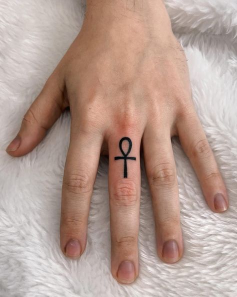 Ankh Tattoos: Meaning, Design Ideas and 30+ Examples - 100 Tattoos Ankh Finger Tattoo, Ankh Tattoos, Cross Finger Tattoos, Warrior Tattoo Sleeve, Ankh Tattoo, Hippie Tattoo, Small Chest Tattoos, Small Girly Tattoos, Tattoos Meaning