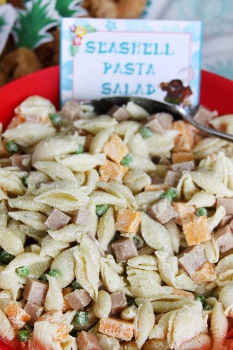 Mermaid Pasta Salad, Seashell Pasta Salad Recipes, She’ll Pasta Salad, Sea Shell Pasta Salad, Vegetarian Luau Party Food, Moana Themed Desserts, Sea Shell Pasta Recipes, Moana Dinner Ideas, Tropical Pasta Salad