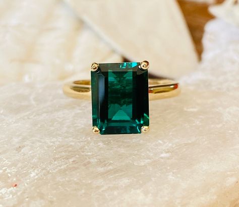 This classic 4 prong cathedral setting contains a beautiful 4.00ct. lab created emerald cut Zambian emerald. The emerald cut stone measures approximately 10x8mm. The ring is available in sterling silver, and 14k white, yellow, or rose gold. This ring makes a great promise or engagement ring. Emerald is the birthstone for May. Please send me a message if you need a size not listed. * This ring can be customized with any color center stone. All items are handmade by me in my shop in Woodbridge, NJ Solitare Engagement Rings, Emerald Solitaire Ring, Stone Ring Design, Engagement Ring Emerald Cut, Emerald Stone Rings, Gold Emerald Ring, Emerald Cut Engagement Ring, Engagement Ring Emerald, Gemstone Rings Vintage