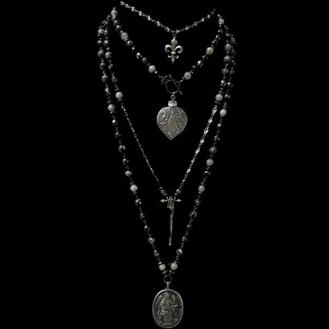 The Lujan Choker features an intricately carved Our Lady of Lujan medal within a flaming Sacred Heart made of Sterling Silver. She's surrounded by Angels, with two of them raising a crown of flowers above her. Pilgrims worldwide travel to see Her and have received special graces, favors and miracles. The gunmetal linked chain is offered in 17" or 22" based on your preference. If you need a longer or shorter size we can make one for you. It's a very special necklace because of the rarity of the m Statement Necklace Long, In Utero Necklace, Silver And Black Necklace, Silver Gothic Jewelry, Trad Goth Jewelry, Ecclesia Jewelry, Long Necklace Outfit, Surrounded By Angels, Goth Jewellery