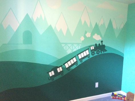 I painted this train mural for my son's bedroom. He's really in to trains and I wanted to do something that will last beyond the Thomas phase. I painted this all by hand, I didn't use any tape. I created the image in Illustrator, and then projected my illustrator file onto his wall and traced it. Then it was just a matter of a steady hand and using a variety of bushes and rollers. Train Murals Wall Art, Train Wall Mural, Train Bedroom For Boys, Train Theme Bedroom, Train Playroom, Train Mural, Train Bedroom, Boys Room Mural, Train Nursery