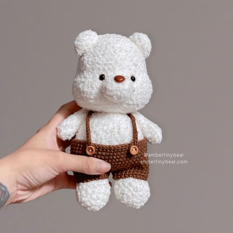 This adorable white bear is all dressed up in its brown pants! The bear's fur is so fluffy and soft, and its eyes are full of mischief 🐻‍❄️ . The pattern is coming soon #ambertinybear #tinyhousevietnam #handmadebyvanh #conngauu #bearpattern #amigurumi #bear #bearcrochet #crochetlove #crochetaddict #amigurumipattern #crochetpattern #amigurumitarifleri #ganchillo #örgü #häkeln #häkelnisttoll #häkelnfürkinder #handmadewithlove #momlife #lebenmitkindern #beabear Crochet Essentials, Shawls Design, Grid Patterns, Amigurumi Bear, Bear Crochet, Kawaii Crochet, Crochet Business, Crochet Work, White Bear