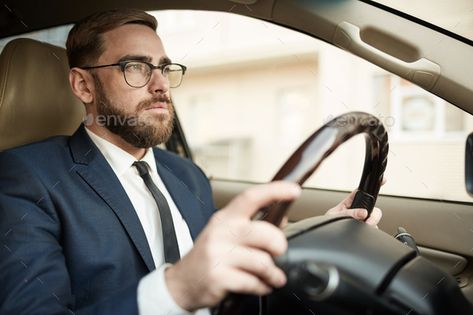 Businessman driving in the car by AnnaStills. Young successful businessman in eyeglasses and in suit sitting in luxury car and driving #Sponsored #AnnaStills, #Young, #car, #Businessman Young Success, Rose Wilson, Talking On The Phone, Human Reference, Body Reference Poses, On The Phone, Anime Expressions, Poses Reference, Human Poses Reference