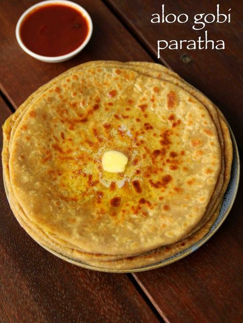 aloo gobi paratha recipe | aloo gobi ke parathe | alu gobi paratha with step by step photo and video recipe. paratha recipes are very common and are typically prepared with a key vegetable stuffing. however in this recipe the stuffing is prepared with fusion of 2 popular paratha stuffing’s. these paratha’s are very filling and is an ideal lunch box or tiffin box recipes relished with spicy pickle and cup of yogurt. Gobi Ke Parathe, Alu Gobi, Gobi Paratha Recipes, Soft Roti, Gobi Paratha, Vegetable Stuffing, Spicy Pickle, Marathi Culture, Hebbar's Kitchen