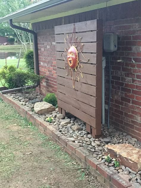 We wanted to somewhat hide the ugly electric meter and cable box, this did the trick after purchasing a large metal sun. Hubby built this out of treated lumber and we both stained it. Hiding Electrical Box On House, Electrical Box Cover, Electric Box, Large Backyard, Casa Exterior, Outside Ideas, Side Yard, Backyard Projects, Patio Designs