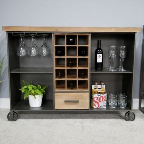 The Industrial Wine Cabinet is the perfect addition to the modern home. Crafted from wood and metal this beautiful cabinet is suited to industrial style interiors. With shelve space, bottle and glass holders and a drawer it provides plenty of storage to become a practical feature in the home.  Dimensions:Height: 85cm  Width: 115cm  Depth: 38cm Cabinet On Wheels, Home Wine Bar, Built In Wine Rack, Industrial Style Home, Wine Bar Cabinet, Sideboard Bar, Wine Display, Wine Cabinet, Drinks Cabinet