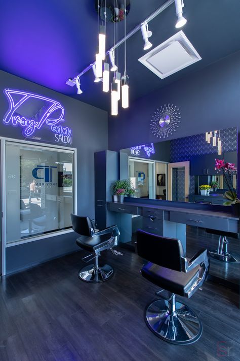 Modern private Salon Studios available for beauty professionals. This hair salon studio in Beverly Hills, California has a blue theme with a wallpaper accent wall and neon sign to create a cool, club feel. Zepeto Background Hair Salon, Navy Blue Hair Salon Decor, Salon Interior Design Purple, Hair Salon Room Decor, Lash Shop Interior, Small Hair Salon Suite Ideas, Blue Salon Ideas, Blue Lash Room Decor, Black Salon Suite Decor