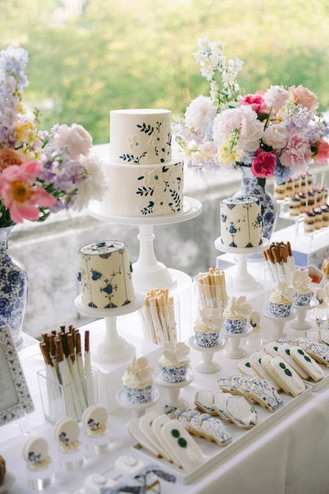 The couple’s dainty white and blue wedding cakes sat on a table of magnificent desserts, all painted in chinoiserie-inspired motifs. Blue And White Dessert Table, Blue White Dessert Table, Blue And White Sweet Table, Blue And White Porcelain Wedding, Blue And White Treat Table, Blue And White Wedding Dessert Table, Chinoiserie Bridal Shower Ideas, Blue Dessert Table, Paris Dessert Table