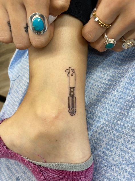 Minimal Lightsaber Tattoo, Matching Lightsaber Tattoos, Rey Lightsaber Tattoo, Star Wars Stick And Poke Tattoo, Minimalist Lightsaber Tattoo, Lightsaber Tattoo Minimalist, Small Nerd Tattoos, Leia Tattoo Minimalist, Starwars Tattoo Small Anakin