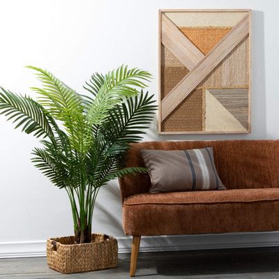 Bring lush greenery indoors with this 4.5' areca indoor palm tree by Sullivans. Its lifelike fronds are sure to give your home a contemporary, botanical feel. As stylish as it is soothing, this palm pairs perfectly with rattan furniture and natural wood accents for an escape to the islands right in your own space. | Primrue 55 Areca Plant Plastic in Black | 55 H x 38 W x 38 D in | Wayfair | Home Decor Indoor Palm, Indoor Palm Trees, Earthy Design, Indoor Palms, Earthy Style, Woven Basket, Rattan Furniture, Lush Greenery, Wood Wall Decor