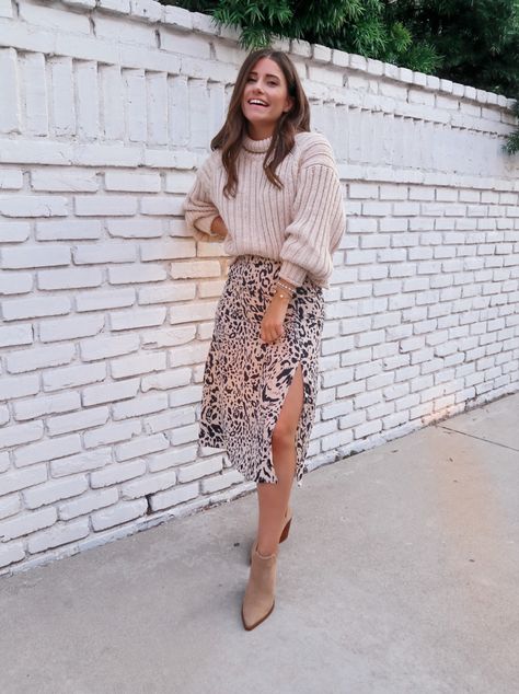 brunette woman wearing leopard print midi skirt , brown ankle booties, and tan oversize turtleneck sweater Midi Skirt Outfit Sweater, Winter Looks Skirt, Midi Skirt Outfit Winter Casual, Ribbed Skirt And Sweater Outfit, Winter Skirt 2023, Cute Fall Dressy Outfits, Dress With Sweater Over It Winter, Womens Midi Skirt Outfit, Fall Outfits With Midi Skirts