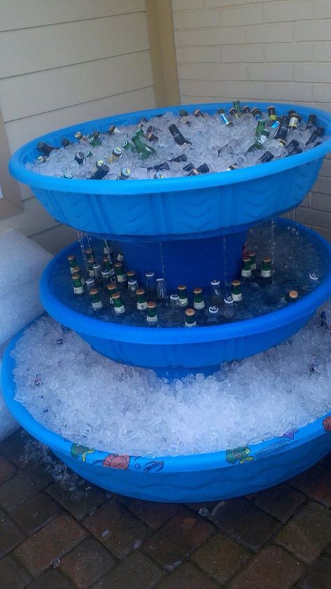 DIY  cooler for your party. With a few plastic (non-inflatable) kiddie pools and a couple of plastic storage bins turned upside down you will have a useful cold storage for your beverages. Drill some hole into the bins so the ice you fill the pools with can easily drip into the one below it. Also, make sure you have different size pools or basins, so the final shape is more like a small fountain and not a tower. Place the beers or sodas in each of the ice-filled pools and let your guests have th Beer Olympic, Drinking Games For Parties, Swim Party, Baby Pool, Batman Party, Kid Drinks, Party Hacks, Kiddie Pool, Beer Bottles