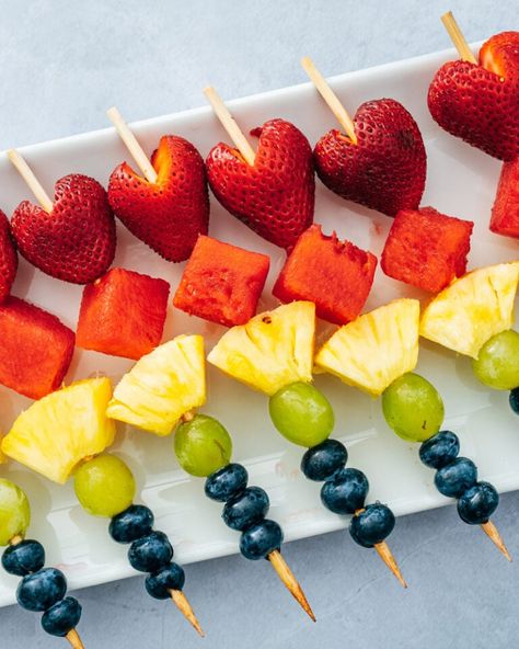 Fruit skewers are a fun and festive appetizer or snack! This healthy treat is easy to make and pleases everyone. #fruitskewers #fruit #skewers #appetizer #easyappetizer #snack #healthysnack #summerappetizer Skewer Fruit Ideas, Berry Skewers Sticks, Fruit Screwers Food Ideas, Mini Fruit Kabobs For Party, Bridal Shower Fruit Skewers, Fruit Shish Kabobs, Fruit Picnic Ideas, Christmas Fruit Kabobs Kids, Small Fruit Skewers