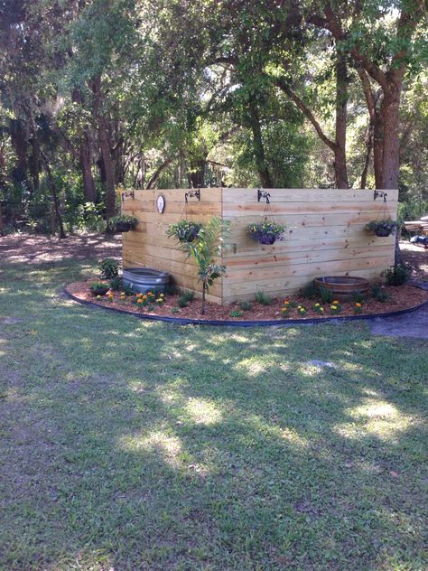 Pretty backyard landscaping to hide well pump. Covering A Water Tank Outside, Covering Propane Tank Ideas, Hide Water Well In Yard, Propane Cover Ideas, Pallet Well Pump Cover, Lp Tank Landscape, Hide Propane Tank Ideas Backyards, Hide Gas Tank In Yard, Hiding Propane Tank In Yard