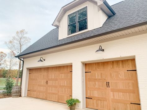 I really wanted the look of wood garage doors but didn’t want the maintenance (or cost!) I loved our C.H.I doors that are stamped to look like wood! We went with carriage house style in “Natural Oak”. White Garage Doors, Faux Wood Garage Door, White Farmhouse Exterior, Carriage House Garage Doors, White Garage, Wood Garage, Modern Industrial Decor, Farmhouse Architecture, Wood Garage Doors