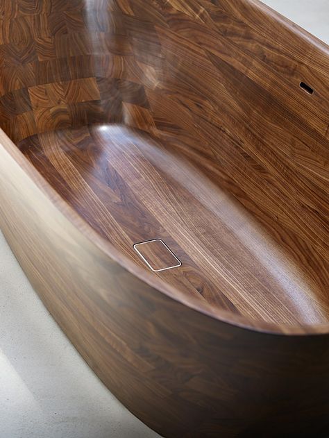 Mair's Shell Bathtub is sculpted from a solid block of walnut using a CNC (computer numerical control) milling machine. "The exacting production process includes precise positioning of every corner and curve, and the ergonomic optimization of every radius and incline," she says. The Shell collection extends to the brass-and-leather stool, which is also available in black steel and leather. Shell Bathtub, Reclaimed Wood Vanity, Wood Tub, Bath Tube, Wood Bathtub, Wooden Wall Design, Wooden Bathtub, Wooden Countertops, Wood Bath