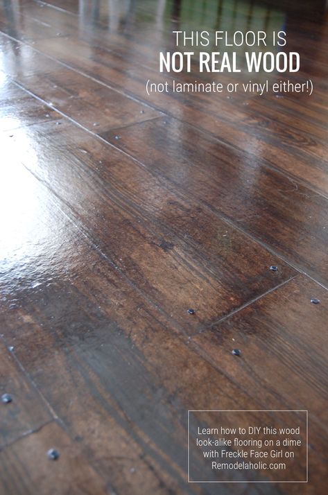 Want the look of a wood floor at a lower cost? This DIY faux wood flooring uses brown paper and costs less than hardwood, laminate, or vinyl tile. #diyflooring #brownpaperflooring #budgetremodel Wood Subfloor Makeover, Faux Wood Concrete Floor Diy, Faux Painted Wood Floors, Faux Tile Concrete Floor, Wood Block Flooring Diy, Faux Wood Flooring Tile, Wood Look Concrete Floor, Painting Plywood Floors Ideas, Faux Stone Floor