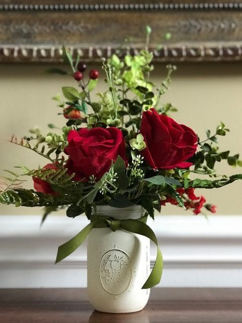 Rich red roses with red berries and dark greenery in painted mason jar style. (Small) Clay Bouquet, Sell Flowers, Bridal Shower Deco, Centerpiece Coffee Table, Valentine Flower Arrangements, Arrange Flowers, Burgundy Lipstick, Mason Jar Centerpiece, Valentine Centerpieces