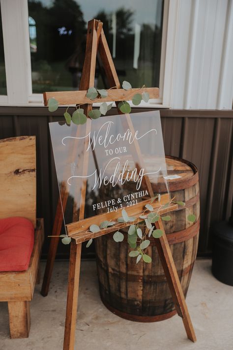 Acrylic board on easel with eucalyptus Acrylic Easel Wedding, Wedding Picture Stand, Wedding Easel Ideas, Acrylic Board Wedding, Welcome Easel, Jesus Wedding, Welcome Sign For Wedding, Wedding Easel, Diy Easel