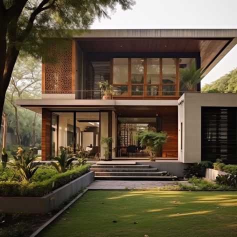 The exterior front of a modern indian house is in the outskirts of the city in the style of layered textures and pattern with trees in yard🌳 ... ... ... #Indian #IndianStyle #NatureInspired #ModernHome #ModernStyle #DreamHouse #TimlessBeauty #Elegance #InstaGood #Content #Tree #NatureInterior #HomeDecor #InspiredArchitecture Green Home Exterior, Pantry Door Ideas, Modern Tropical House, Asian House, Tropical House Design, Contemporary House Exterior, Kitchen Transformation, House Arch Design, Modern Exterior House Designs