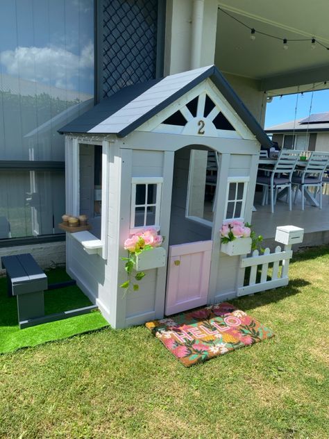 Cubby house with mail box and window for kids coffee maker. Painted in grey with a pink door and white trims. Pink flowers in the window sills and a floral door mat. Cubby House Ideas, Baby Penelope, Kmart Australia, Kids Cubby Houses, Kids Cubbies, House Bedroom Ideas, House Colours, Backyard Adventure, Cubby House