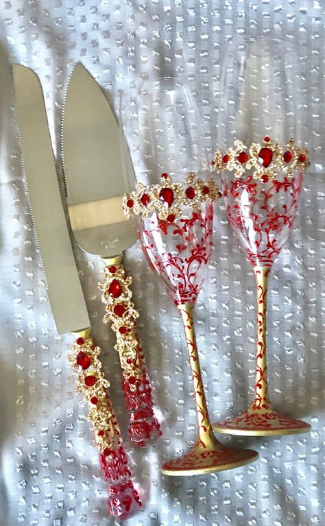 This beautiful red and gold hand painted wedding accessory set includes all you need to celebrate in style your newlywed status. Embellished with jewel-like beads, the set includes toasting flutes, cake server set, and unity candle ceremony set and is also available by individual pieces. Personalized with your names and the date of your wedding this set makes for a cherished heirloom of your special day. Red Gold Cake, Red Quinceanera Theme, Red Quince Theme, Red And Gold Quince, Red Quinceanera Ideas, Gold Champagne Flutes, Red Gold Wedding, Gold Wedding Set, Wedding Cake Server Set