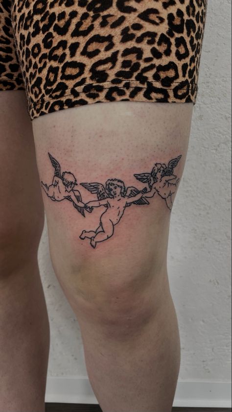 2003 Tattoo Above Knee, Angel Above Knee Tattoo, Cherub Above Knee Tattoo, 2 Cherub Angel Tattoo, Two Cherub Angel Tattoo, Unique Cherub Tattoo, Tattoo Above Knee, Finger Tattoos Words, Simple Leg Tattoos