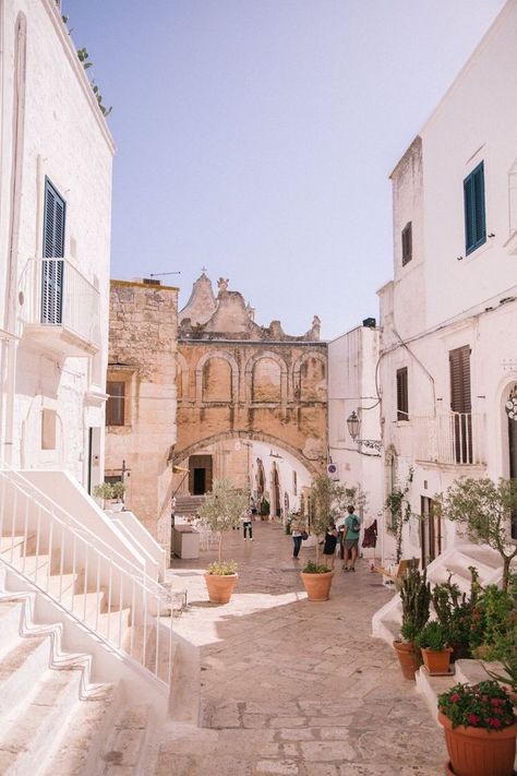 Ostuni is a unique town that resembles a bright cap rising up right from the flat plains near the southern coast of Italy. Its whitewashed defensive walls and houses inside the old town with many winding streets, steps and beautifully decorated, colorful window frames can make you think you're somewhere in Greece. Although Ostuni is one of the main attractions in Puglia, it's less known than Polignano a Mare or Alberobello famous for its cone-shaped Truli houses. And the whole region of Pu Ostuni Puglia, Puglia Italy, Wanderlust Travel, Travel Inspo, Pretty Places, Dream Destinations, Puglia, Travel Aesthetic, Italy Travel