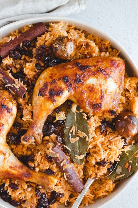 This chicken machboos recipe (also known as Kabsa) is a delicious Arabic rice dish from Saudi Arabia. Spiced rice cooked to perfection served with chicken legs, topped with toasted pine nuts and raisins. #machboos #chickenmachboos #kabsa #arabicrice #arabicrecipe Machboos Recipe, Chicken Machboos, Kabsa Recipe Chicken, Kabsa Recipe, Arabic Rice, Chicken Mandi, Middle East Recipes, Arabian Food, Spiced Rice