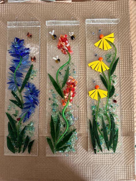 Spring garden fused glass sun catcher. Bright, cheerful flowers reaching for the sun after a long winter rest! Dimensions: 3" x 12" Choose your favorite in comments. Price is for one #GlassygirldesignsUS Fused Glass Window, Fused Glass Garden Art, Fused Glass Suncatcher, Fused Glass Spring Ideas, Fused Glass Flowers, Fused Glass Abstract Art, Fused Glass Leaves, Fused Glass Ideas, Fused Glass Animals Garden Art