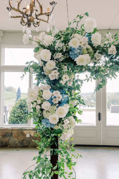 A dreamy white and blue floral design| wedding flowers,flowers for wedding,floral wedding,flower arrangements,floral installation,floral inspiration,event floral design,floral details,wedding flowers,wedding ceremony,wedding ceremony decoration,wedding ceremony decor ideas,elegant wedding,wedding details,wedding stuff,wedding decorations,elegant wedding decro ideas,wedding planning,wedding stylist,wedding florist,indoor wedding,indoor wedding ceremony,2022 wedding,winter wedding White And Blue Arch Wedding, Blue And White Wedding Arbor, White And Green Florals For Wedding, Blue And White Floral Arch, Blue Ceremony Arch, White And Blue Wedding Arch, Blue And White Sweetheart Table, Blue And White Wedding Arch, Wedding Arch Ideas Indoor