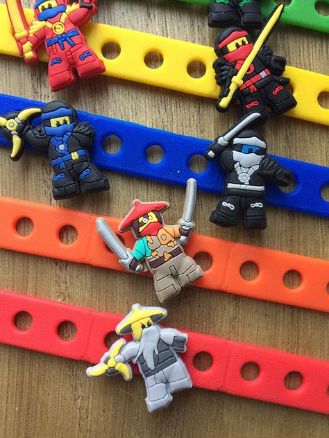 Lego Ninjago Carm Bracelets Party Favors | CatchMyParty.com #catchmyparty #partyideas #ninjago #legoninjago #birthdayparty Lego Ninja Party Favors, Lego Ninjago Party Favors, Ninjago Birthday Party Decorations, Ninjago Party Ideas, Ninjago Party Favors, Ninja Party Favors, Lego Ninjago Birthday Party, Ninja Birthday Party Ideas, Ninja Party Favor