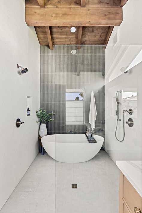 Modern bathroom with a freestanding tub and exposed wooden beams. www.fiori.com.au #bathroom #bathroomideas #bathroomdesign #designingabathroom #bathrooms #majorbathroomdesign #bathroomrenovation #bathroomdesignideas #modernbathroomdesign #bathroomrenovationideas #bathroomrenovationideasSydney #bathroomdesigntrends #bathroomdesignlayout Exposed Beams Ceiling Bathroom, Custom Front Door, Luxury California, Traditional Meets Modern, Exposed Beams Ceiling, Latest Bathroom Designs, Manhattan Beach California, Custom Front Doors, Bathroom Design Layout