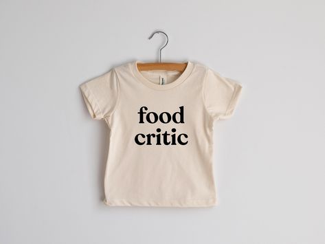 For wee ones with a refined and sophisticated palate! For wee ones with a refined and sophisticated palate! This modern tee for little ones features a fun, groovy typeface and was designed with love and screen printed by hand in-house in crisp black ink. Natural cream cotton is 100% organic. A funny outfit for picky eaters and tricky-to-feed toddlers. All artwork is original. Sizes available in: * 3-6 Months * 6-12 Months * 12-18 Months * 18-24 Months * 2T * 4T * 6T * Youth Small * Youth Medium Groovy Typeface, Toddler Tshirt Ideas, Kids Tshirt Ideas, Kids Clothes Diy, Toddler Graphic Tee, Funny Toddler Shirt, La Shirt, Cool Kids Clothes, Food Critic