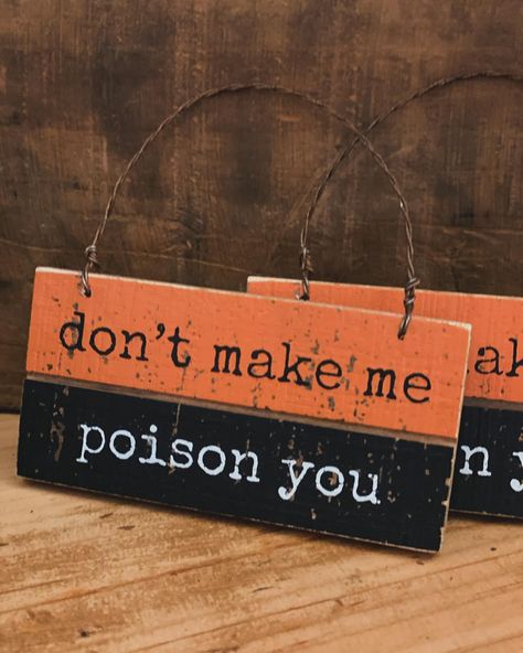 A slat wood ornament displaying a fun Halloween themed sentiment that reads "Don't Make Me Poison You." Seasonal slat ornament features classic Halloween color palette with distressed details for added interest. Our Poison You slat ornament is easy to hang via the attached twisted wire loop. A rustic seasonal home accent that can be easily displayed in any home or work space. Dimensions: 4" x 2" x 0.25" Material: Wood, wire hanger Halloween Signs Diy Wood Crafts, Fall Signs Wooden Diy, Wood Sign Ideas, Tag Signs, Halloween Color Palette, Halloween Sayings, Spooky Crafts, Wood Block Art, Door Tag