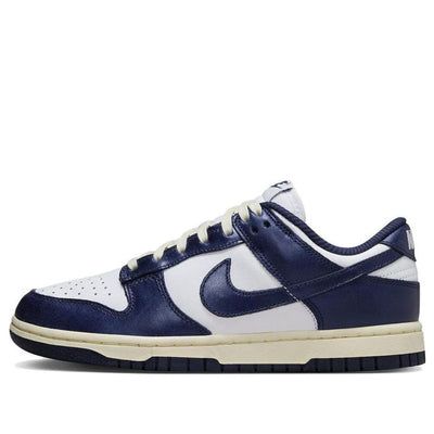 The Nike Dunk Low PRM Vintage Navy is a timeless classic with a fresh twist. This iconic silhouette features premium tumbled leather in a classic navy hue, accented by muted white panels and a signature Nike Swoosh. The vintage-inspired details, like the distressed midsole and yellowed lace tips, add a touch of nostalgia. Experience the ultimate blend of style and comfort with this must-have sneaker. Nike Shoes Women Dunks, Cheap Back To School Shoes, Navy Dunks Outfit, Navy Nike Shoes, Navy Blue Dunks, Dark Blue Dunks, Navy Blue Nike Dunks, Navy Dunks, Dark Blue Nike Dunks