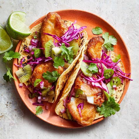 These healthy fish tacos can be made with cod or any other firm white fish. A lively kiwi salsa and red cabbage brighten up the colors and flavors of the crispy tacos and complete this easy dinner recipe. The key to perfectly golden, crunchy fish is patience--let your oil get nice and hot before you add in the battered pieces. Dip an instant-read thermometer into the oil to make sure it's up to temp before you get cooking. Kiwi Salsa, Healthy Fish Tacos, Easy Fish Tacos, Fish Tacos Recipe, Healthy Fish, Baked Fish, Mango Salsa, Fish Tacos, Mediterranean Diet Recipes