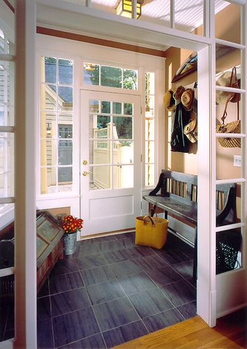 This mudroom addition creates a perfect dropping ground before you enter the new family room. A slate floor is forgiving of muddy and wet feet and makes for easy clean up. Lots of light with transoms into the interior family room and exterior adds function to beautiful form. Photography: John Umberger; Real Images 2002 Chrysalis Award - Addition Over $250K Junior League Tour of Kitchens 2002 Featured in Sept 2003 Better Homes Gardens Magazine  Sunny Dispositions Featured in Oct 2006 Atlanta Home Mudroom Addition, Vstupná Hala, Mud Room Entry, Mudroom Entryway, Half Walls, Room Additions, Laundry Mud Room, Room Remodeling, Design Living Room