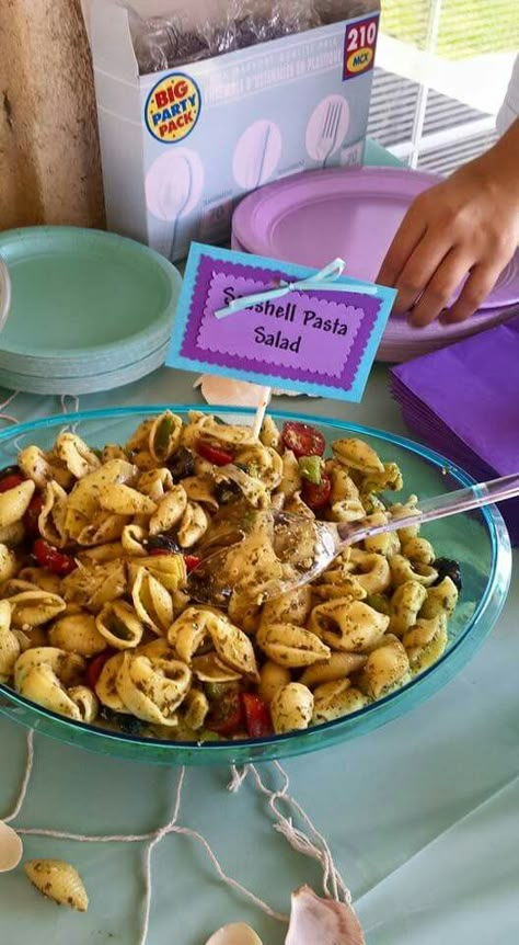 Seashell Pasta Salad - tortellini basil pesto pasta salad using shell noodles Mermaid Dinner Food, Sea Themed Dinner, Seashell Pasta Salad, Under The Sea Snacks, Shell Pasta Salad, Ocean Theme Snacks, Basil Pesto Pasta Salad, Seashell Pasta, Sweet 16 Food Ideas