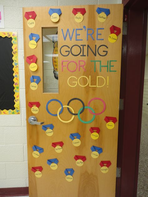 An Olympic Themed Classroom- Door, behavior chart, and bulletin board! Go for the Gold! Diy Olympics Decorations, Olympics School Theme Bulletin Boards, Summer Olympics Bulletin Board Ideas, Olympics Summer Camp Theme, Olympics Door Decor, Go For The Gold Bulletin Board, Olympic Theme Door Decorations, Olympic Classroom Door, Olympic Theme Bulletin Board Ideas