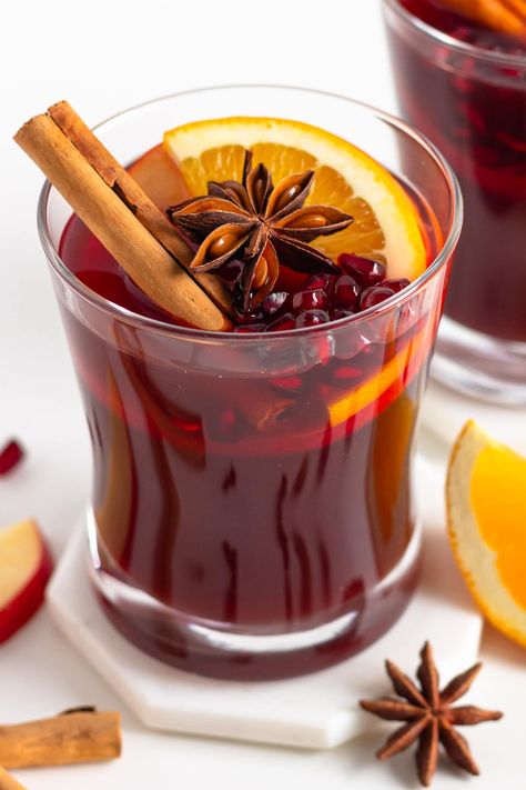 Stay festive and skip the booze with this easy homemade non-alcoholic mulled wine recipe (aka Kinderpunsch). A super delicious, warm and cozy Christmas mocktail that everyone can enjoy! Both kids and adults will love this family friendly German non alcoholic Christmas punch - tastes like Christmas in a cup! | www.mapleandmango.com Alcoholic Christmas Punch, Non Alcoholic Mulled Wine, Non Alcoholic Christmas Punch, Christmas In A Cup, Christmas Mocktail, Winter Mocktails, Christmas Mocktails, Holiday Beverages, Mulled Wine Recipe