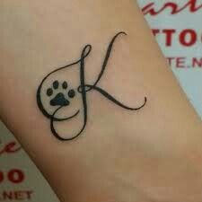 Paw Prints With Initials Tattoo, Paw Print Tattoo Dog Initial, Paw Print Initial Tattoo, Cat Initial Tattoo, Dog Initial Tattoo Ideas, Tattoos In Honor Of Dogs, Dog Initial Tattoo, Paw Print Tattoo With Initial, Dog Paw Tattoo Memorial