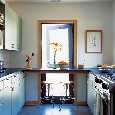 replacing a window at one end of the galley-like space with a glass Dutch door and wrapping three sides of the room with a counter. The counter passes in front of the Dutch door, becoming a breakfast bar; light coming through the door washes the floor and walls.(removable counter in front of door) Monochrome Kitchen, Breakfast Bar Lighting, Beautiful Kitchen Designs, Breakfast Bar Kitchen, Floor To Ceiling Windows, Home Trends, Kitchen Makeover, Kitchen Layout, Beautiful Kitchens