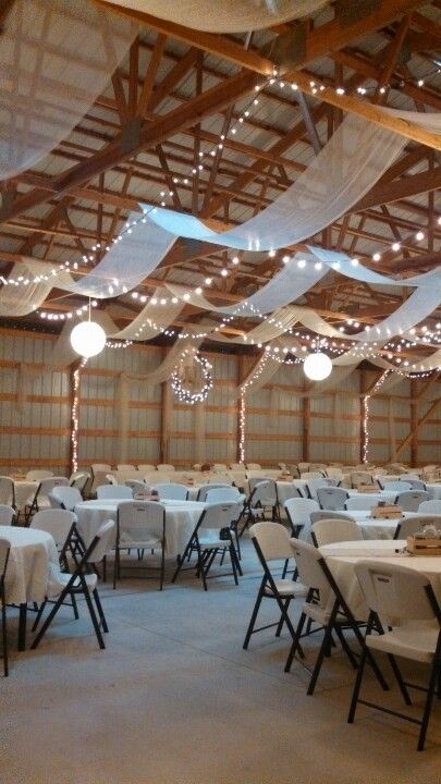 Machine Shed Wedding Reception Decor, Pole Building Wedding Reception, Shop Wedding Reception Decor, Indoor Wedding Receptions Simple, Simple Wedding Ceiling Decorations, Metal Building Wedding Reception, Boho April Wedding, Wedding Shed Decorations, Wedding Reception In Garage