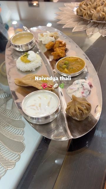 Srushti on Instagram: "Guess who’s waiting for Prasadam now? 😋 ❓Why do we present Naivedya to the idol? 🌺 Naivedya means food offerings made to god. 🌺 Naivedya offerings are made with deep reverence and devotion, symbolizing the act of surrendering to the divine. 🌺 The thali is usually placed on a circle drawn with water on the floor close to the idol’s feet. A small glass of water is placed with it on the right. 🌺 It is believed that when the offerings are presented to the deities, they p Silver Utensils, Silver Things, Silver Goddess, Thali Decoration Ideas, Fine Dinnerware, Pooja Items, Ganpati Decoration Design, Silver Pooja Items, Pooja Room Door Design