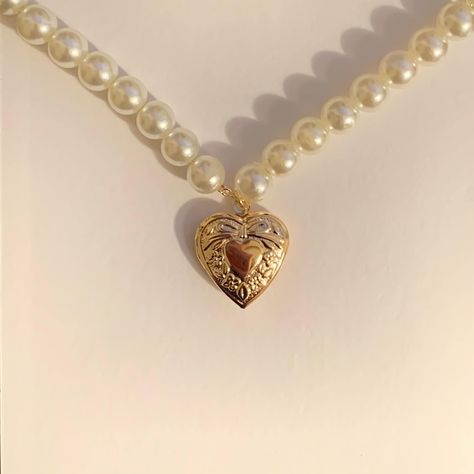 introducing our pearl ethereal necklace. the pearl ethereal necklace is made of 2mm dainty gold plated chain with 8mm white pearl beads and an 18k gold heart locket to fit a small picture of a loved one (23mm x 19mm). find us on - depop: @milanajewelry instagram: @milanaajewelry (usa shop) @milanajewelryaz (european shop)  tiktok: @milanajewelry Gold Heart Locket, Aesthetic Retro, Heart Locket Necklace, Gold Bead Necklace, Pretty Necklaces, Heart Locket, The Pearl, Girly Jewelry, Dream Jewelry