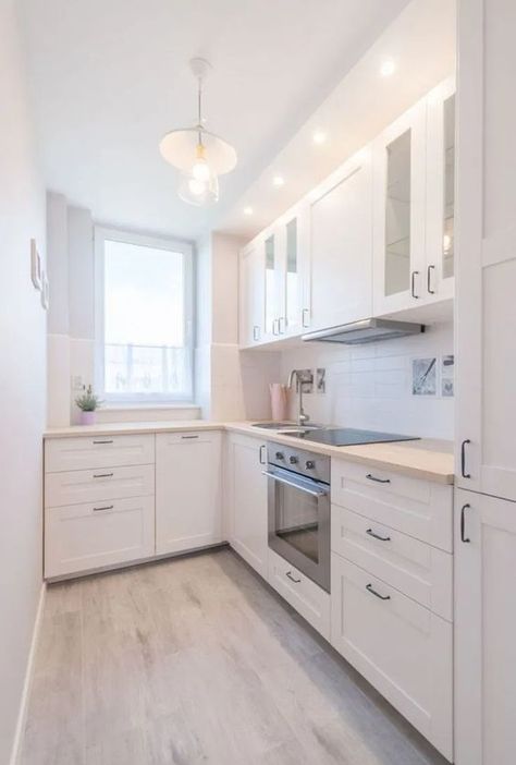 a modern white L shaped kitchen with a white tile backsplash and light stained butcherblock countertops L Shaped Kitchen Layout, Small L Shaped Kitchens, Galley Kitchen Remodel Ideas, L Shaped Kitchen Designs, Small White Kitchens, Small Galley Kitchen, Layout Kitchen, Tiny Kitchen Design, Small Modern Kitchens