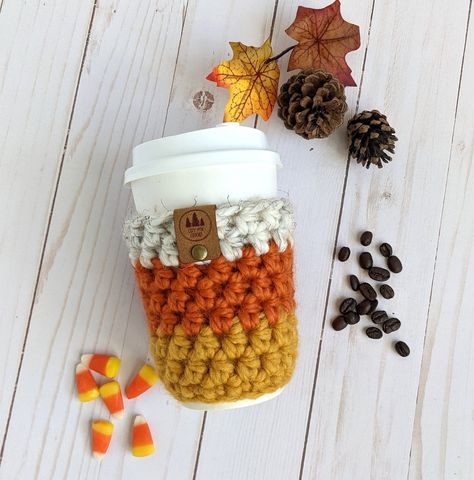 "Add some Fall fun and coziness to your coffee or tea To-Go cup with this adorable Candy Corn style crocheted coffee sleeve. This fun cup cozy is sure to brighten your day! This reusable sleeve is easy to carry with you to slip onto your coffee To-Go cup in place of the cardboard sleeve.  Use this cozy to protect your fingers from hot beverages while adding fun to your day! Made with soft, chunky acrylic/wool blend yarn, the Cup Cozy is hand washable in cool and line dry. //SIZE One size will fi Pumpkin Cup Cozy, Crochet Coffee Sleeve, Candy Corn Pumpkin, Fall Crochet Projects, Cup Cozy Pattern, Crochet Mug Cozy, Crochet Coffee Cozy, To Go Cup, Pumpkin Cups