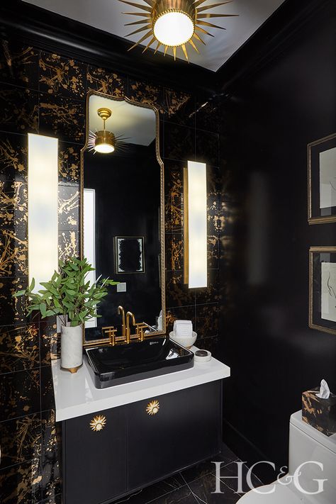 Eryn Oruncak channeled “romantic glamour” for her powder room, which features glossy black walls, black wall tile with gold splatter from The Tile Shop, and a floating black Kohler vanity. Thomas O’Brien’s Albertine sconces for Circa Lighting and Oruncak’s own artwork add another layer of sophistication. Powder Room by Elan Design, Photograph by Anastassios Mentis Black Powder Room, Downstairs Wc, Moody Bathroom, Black And Gold Bathroom, New House Bathroom, Dark Bathrooms, Powder Room Decor, Art Deco Bathroom, Powder Room Design