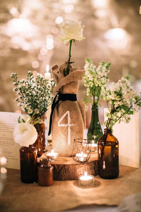 42 Rustic Wedding Centerpieces Fancy Ideas ❤ rustic wedding centerpieces burlap white flowers and candles frasersteartphotography #weddingforward #wedding #bride #rusticwedding #rusticweddingcenterpieces Burlap Table Decorations, Candle Table Numbers, Rustic Centerpieces Diy, Table Numbers Wedding Rustic, Bottle Centerpieces, Candle Wedding Centerpieces, Rustic Fall Wedding, Rustic Centerpieces, Rustic Wedding Centerpieces